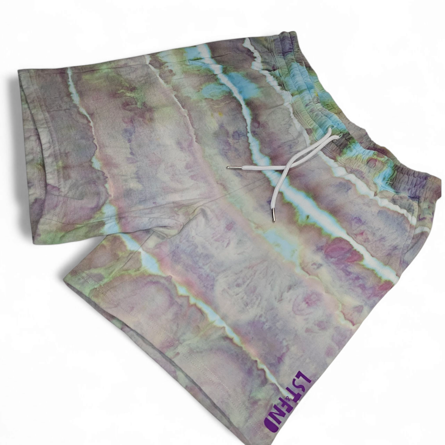 “Alchemy Lights tie-dye shorts with purple and teal stripe pattern, LST FND logo on hem”